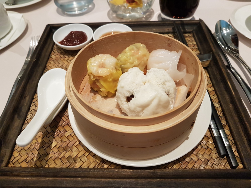 a bowl of dim sum on a tray