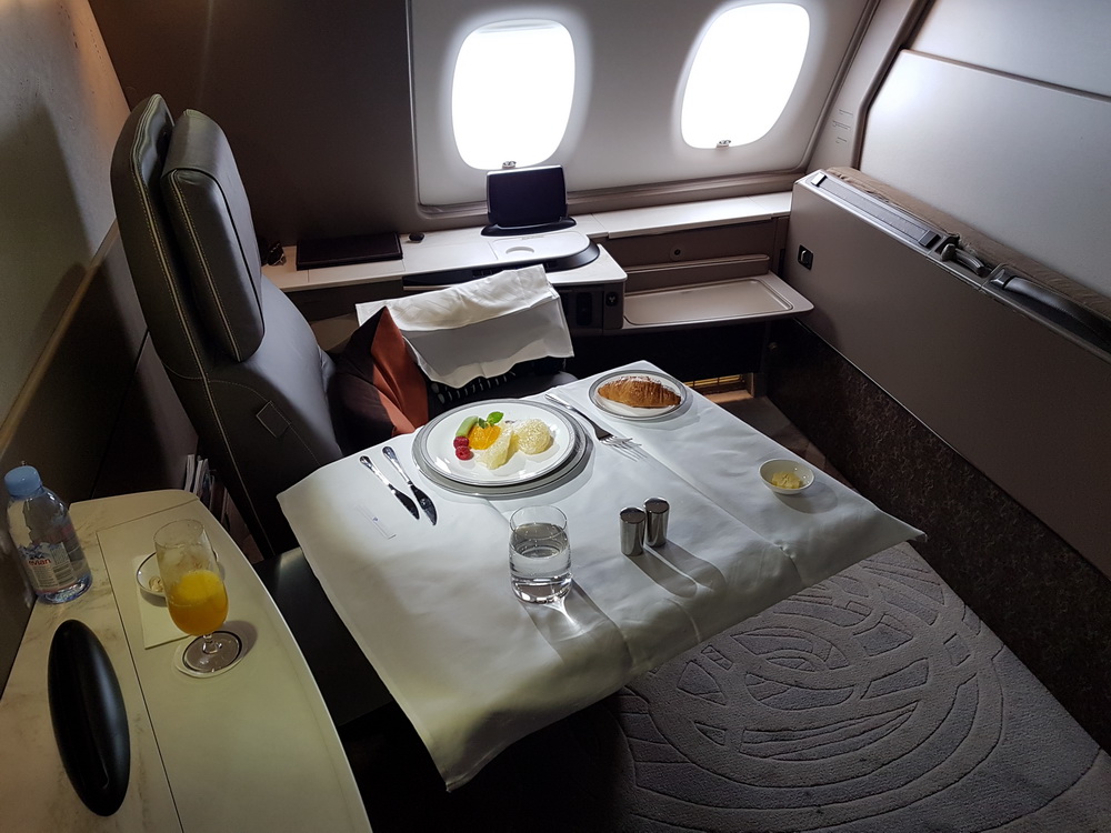 a table with food on it in an airplane
