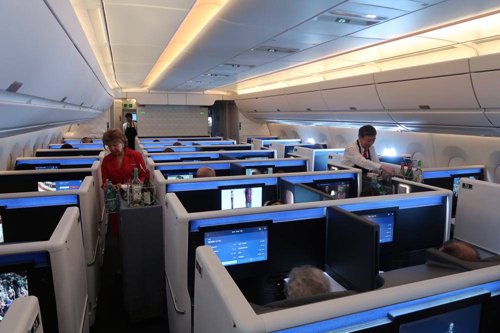 people in an airplane with people sitting in chairs