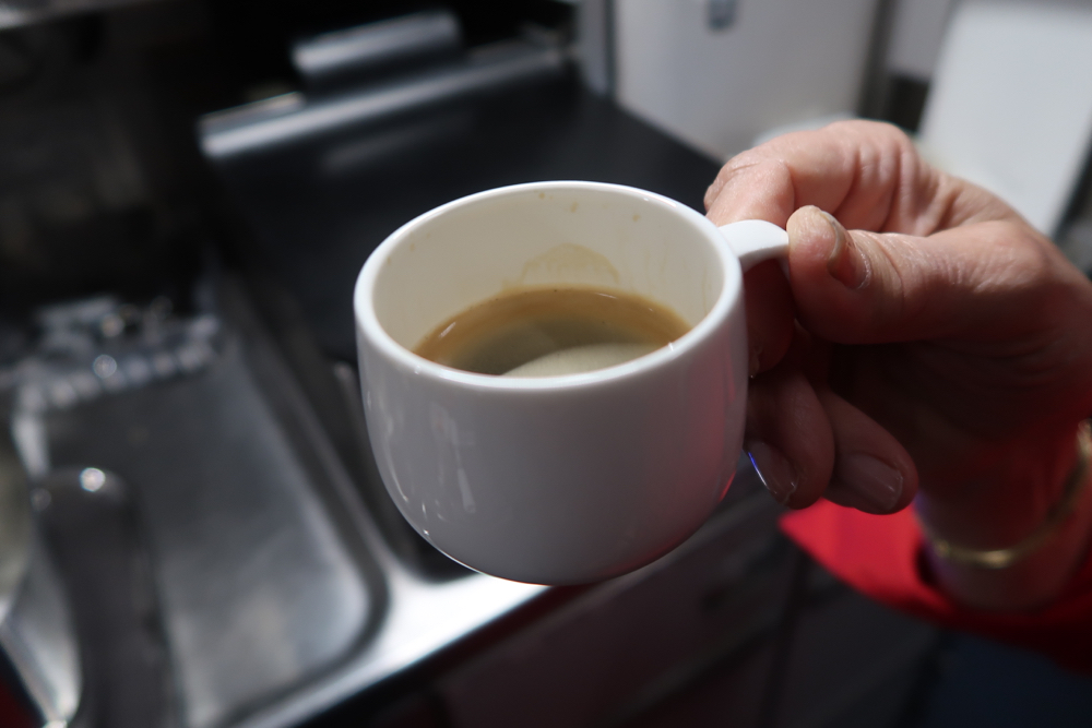 a hand holding a cup of coffee