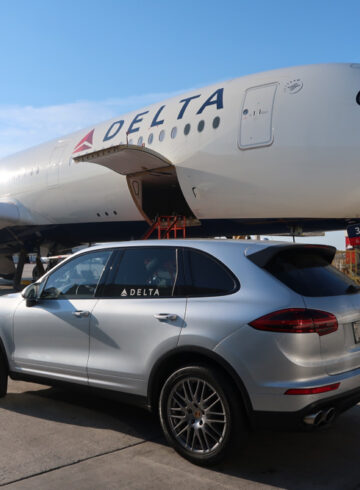 a car parked next to a large airplane