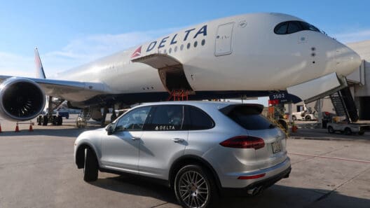 a car parked next to a large airplane