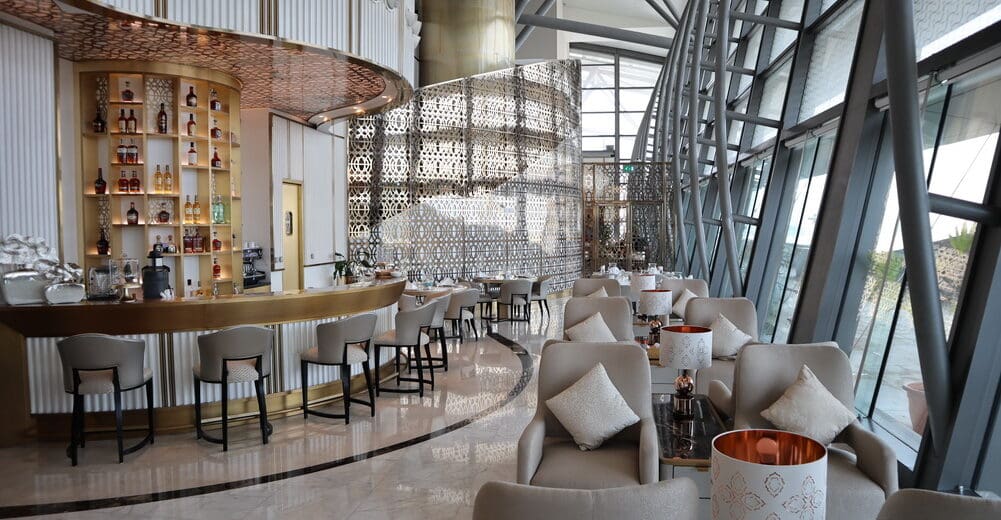 a room with a bar and chairs