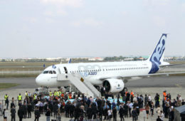 a group of people standing around an airplane