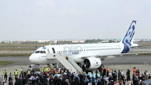 a group of people standing around an airplane