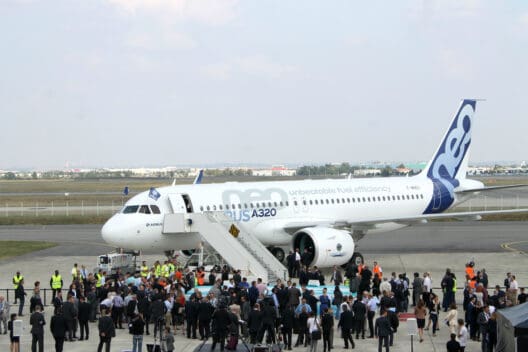 a group of people standing around an airplane