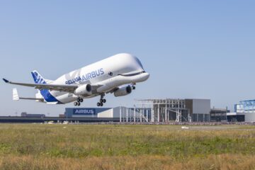a large white airplane taking off
