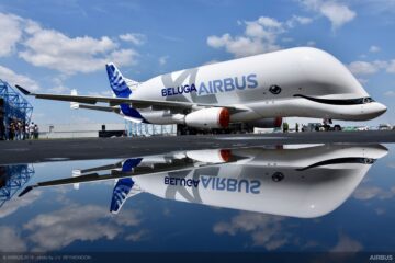 a large white airplane with blue and white text on it