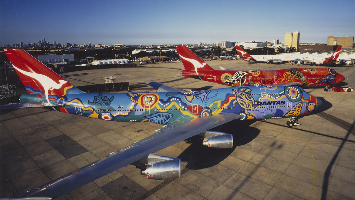 a colorful airplanes on the tarmac