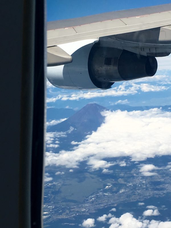 an airplane wing with a mountain in the background