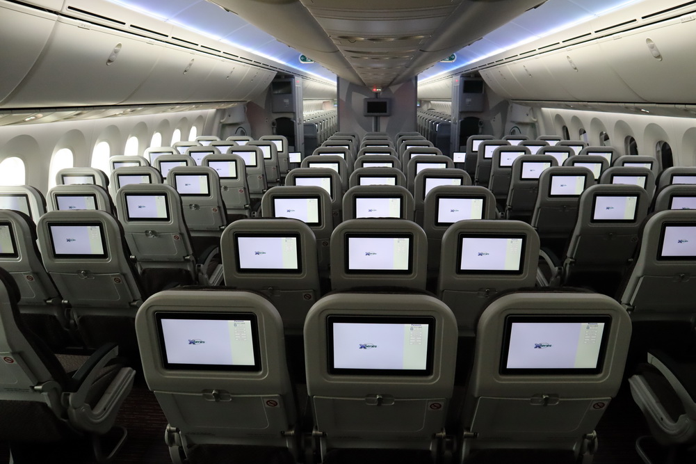 rows of seats with monitors on them