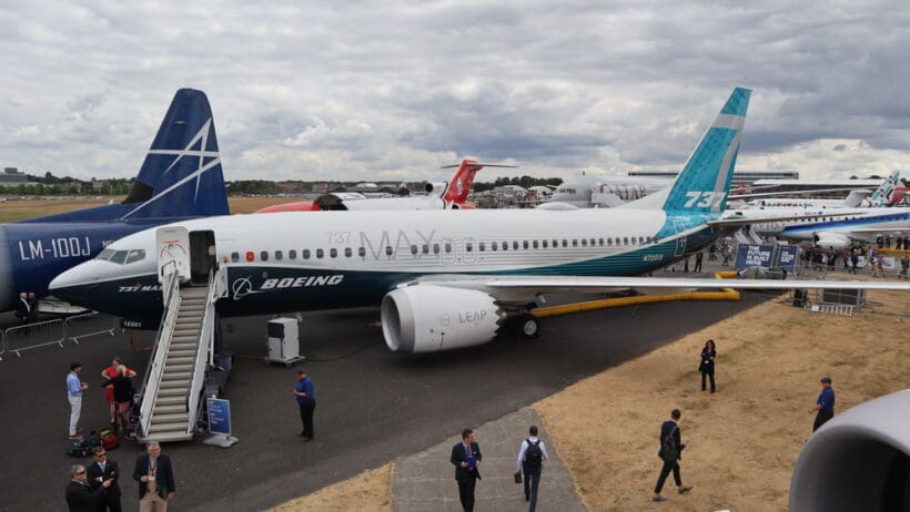a group of people walking around an airplane