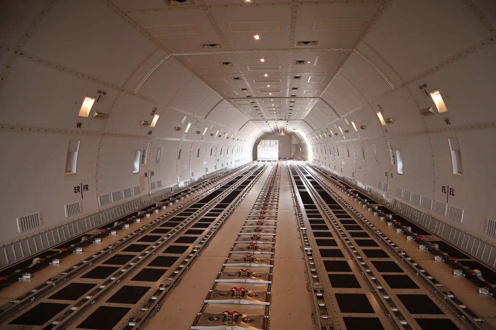 inside a large white tunnel with many metal rails