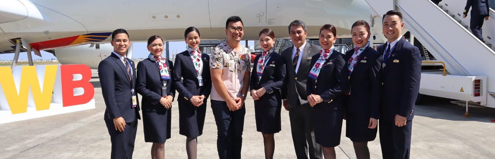 a group of people standing in front of an airplane