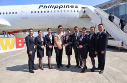 a group of people standing in front of an airplane