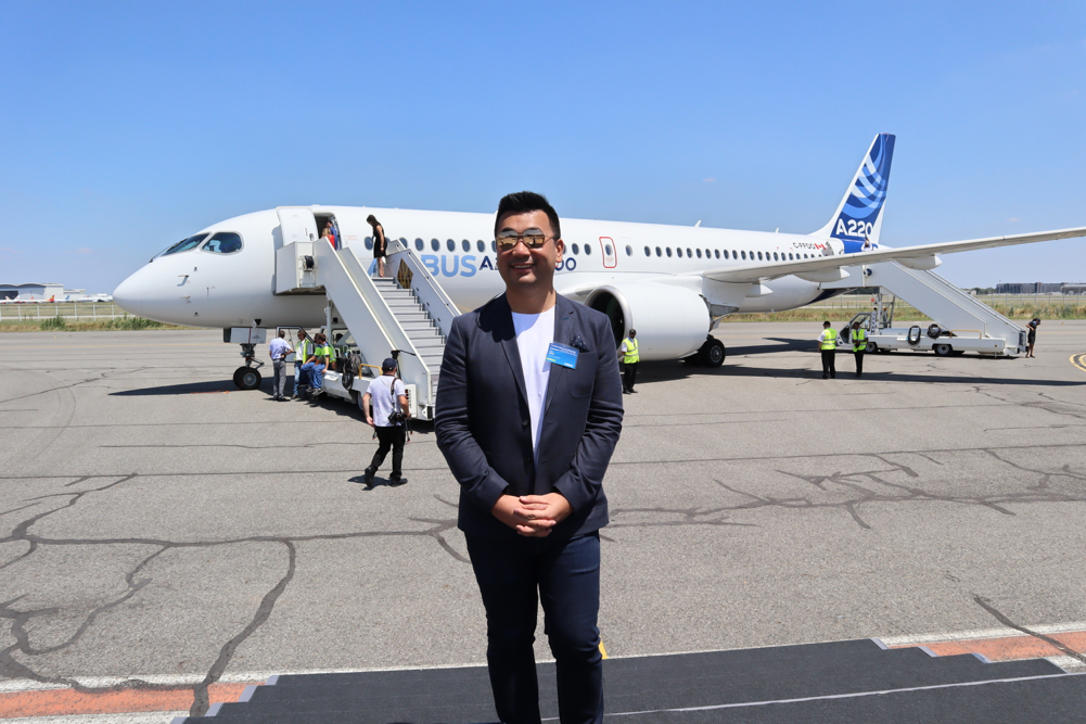 a man standing in front of an airplane