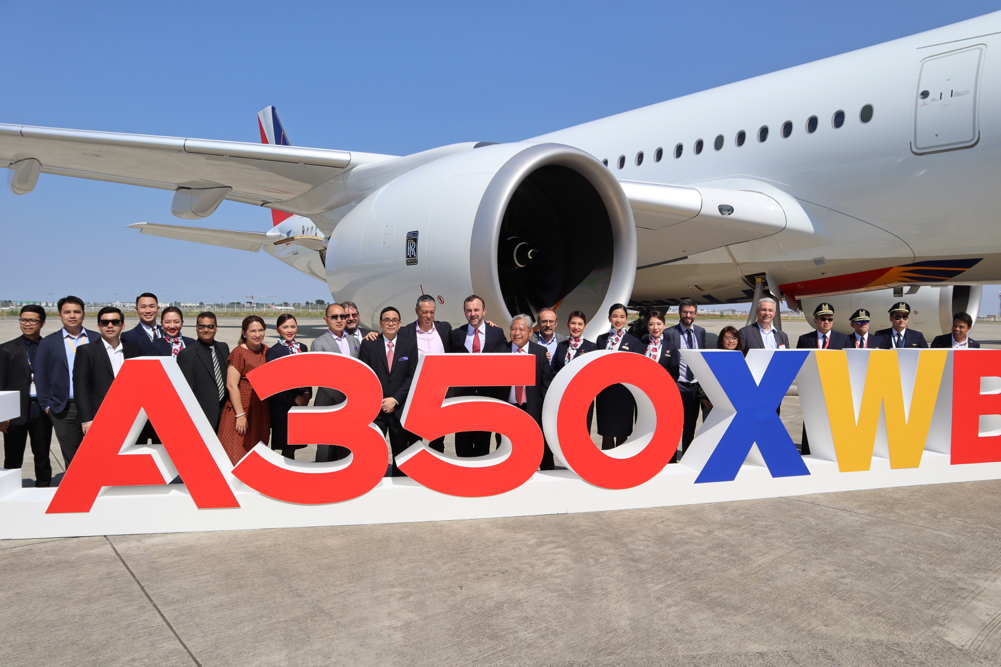 a group of people standing in front of a large white airplane