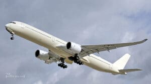 a large white airplane flying in the sky