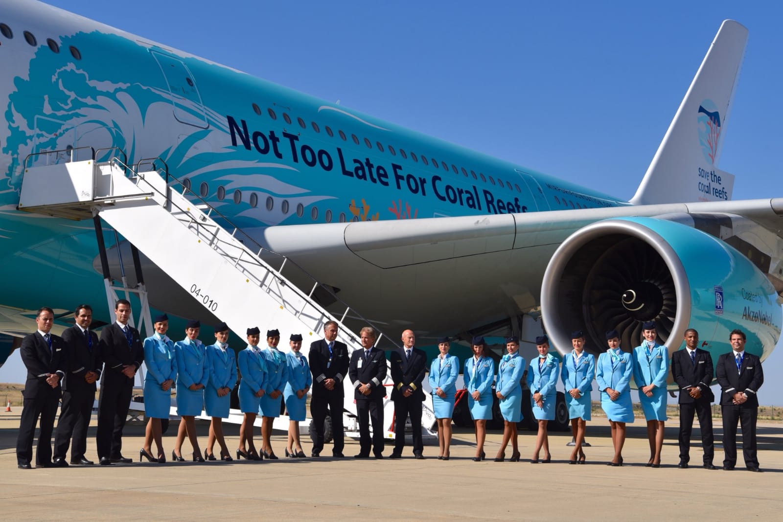 a group of people standing in front of an airplane