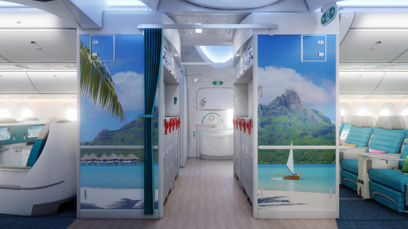 a bathroom with a picture of a beach and a boat