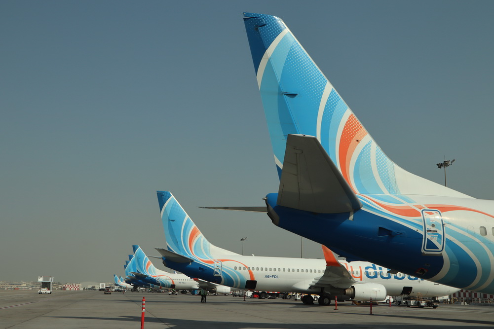 a group of airplanes parked on a runway