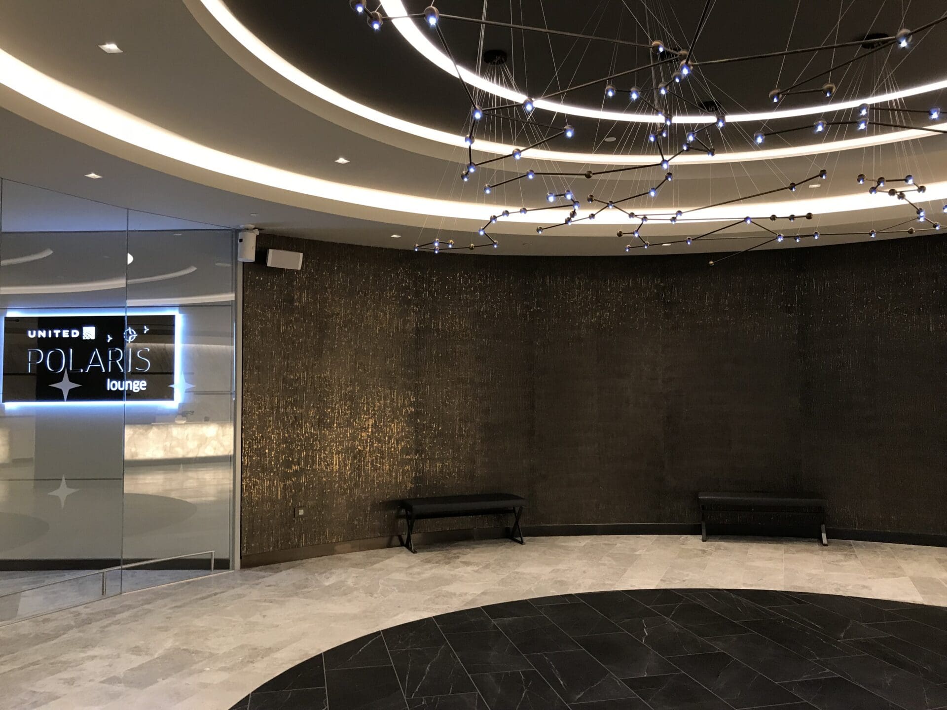 a room with a chandelier and a sign