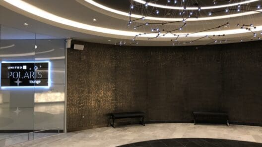 a room with a chandelier and a sign