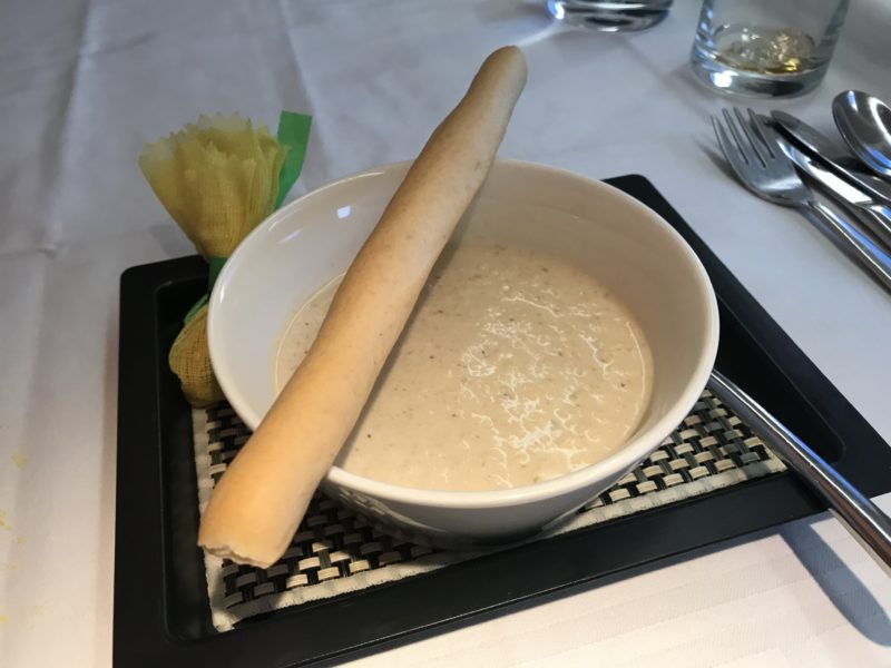 bowl of soup with sticks in it