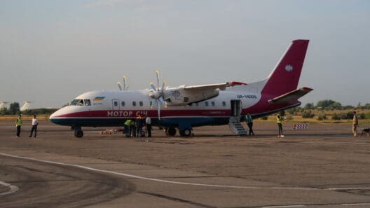 a group of people standing next to a plane