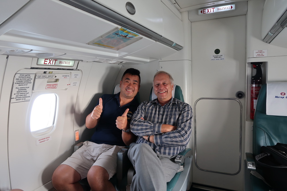 two men sitting in a plane