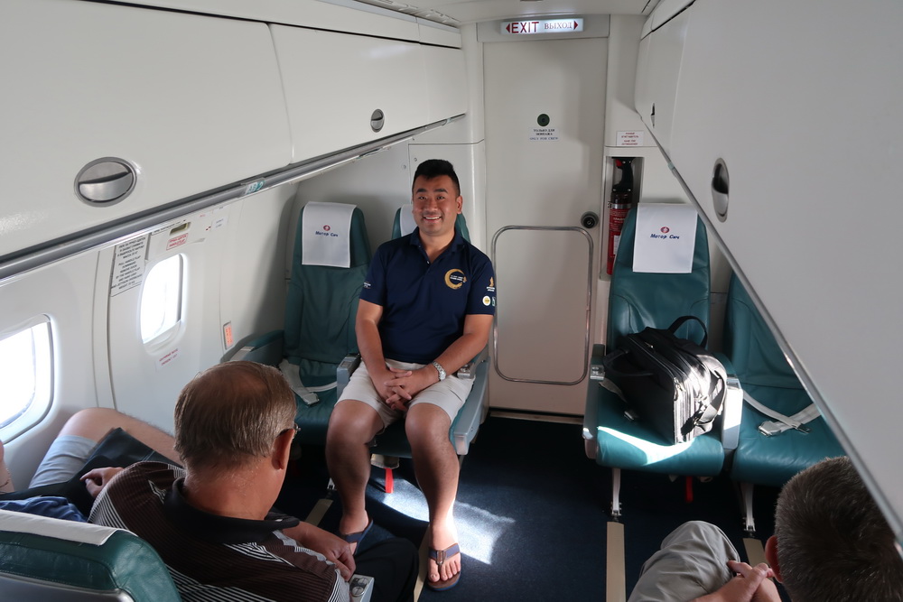 a man sitting in a chair in a plane