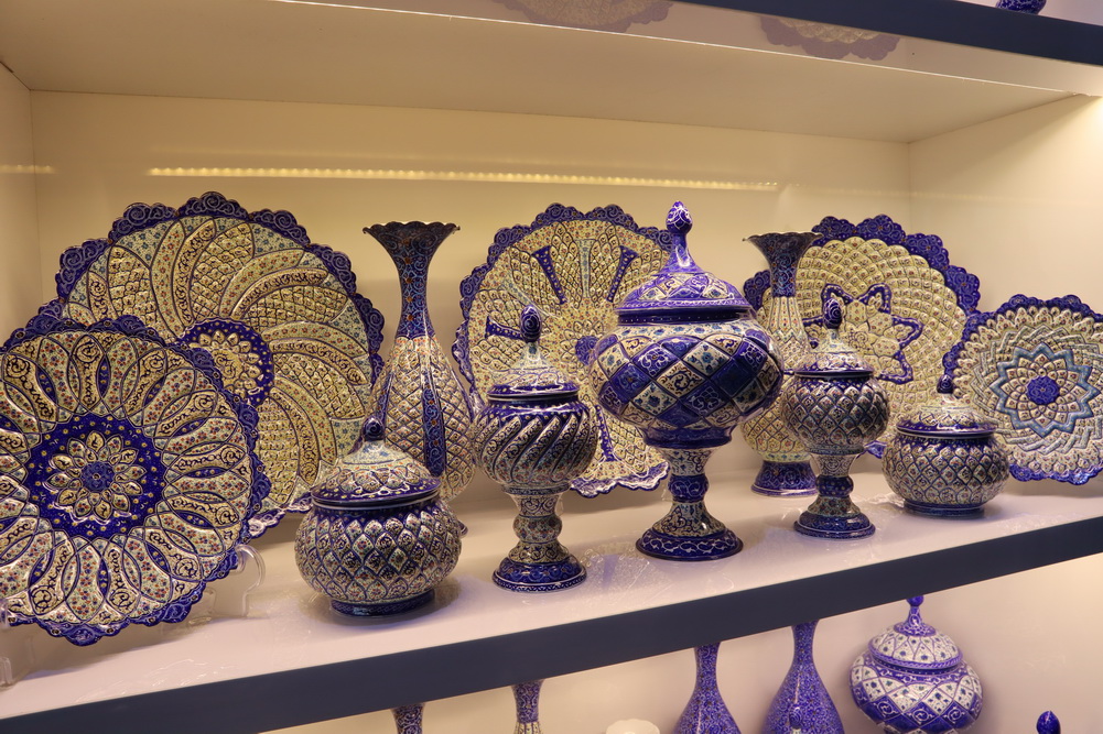 a display of blue and gold pottery