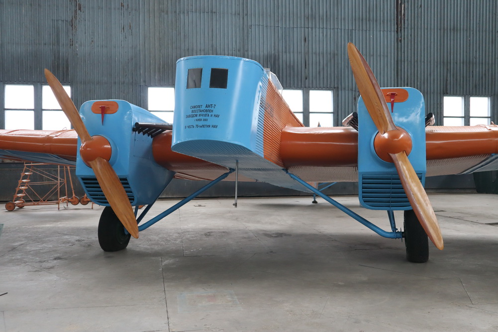 a blue and orange airplane in a hangar