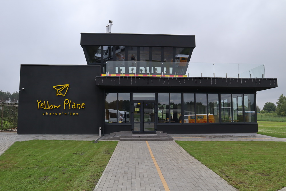 a building with a glass wall and a sign