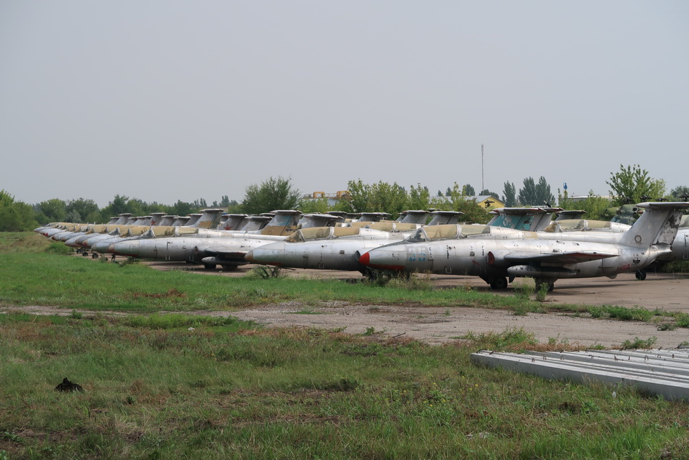 a group of airplanes parked in a field