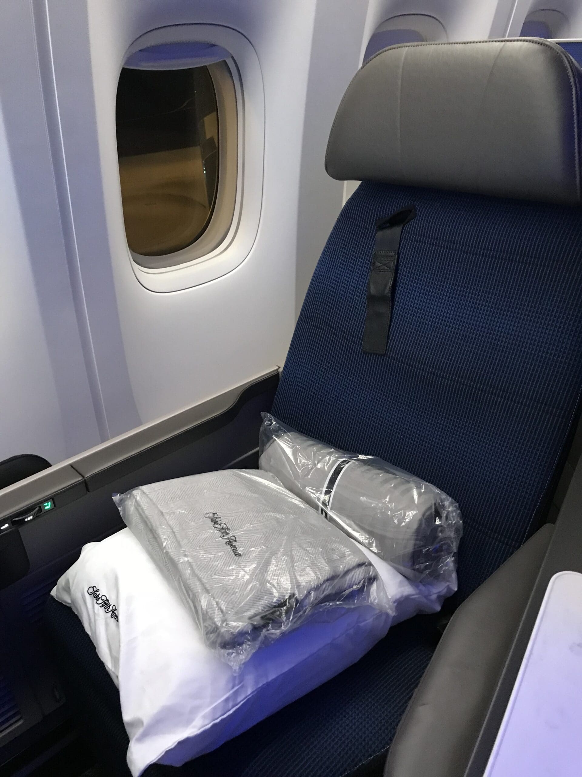 a seat with a bag of clothing on it