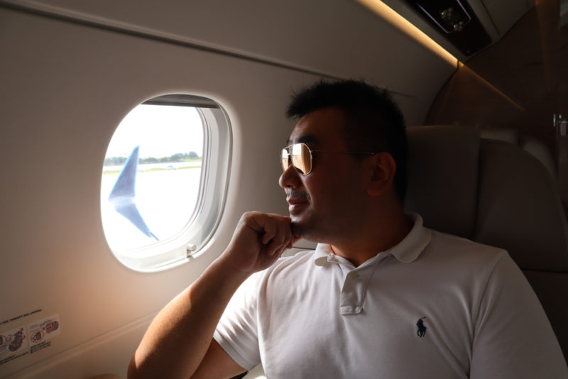a man sitting in a plane looking out of a window