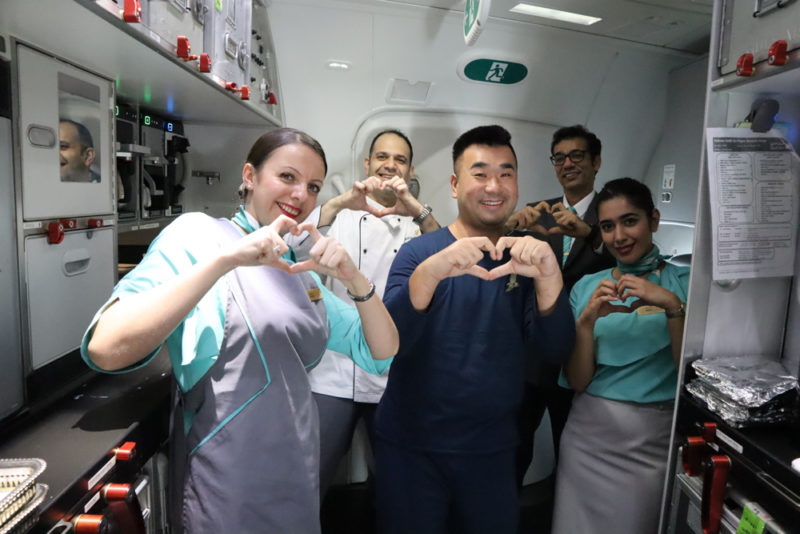 a group of people making a heart with their hands