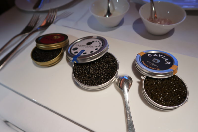a group of black caviar in a jar