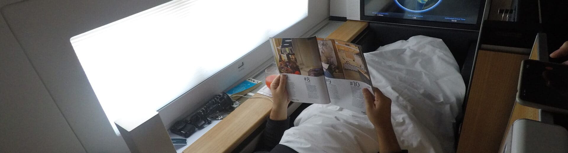 a man lying in bed reading a book