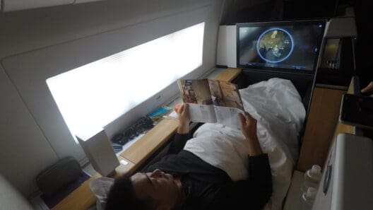 a man lying in bed reading a book