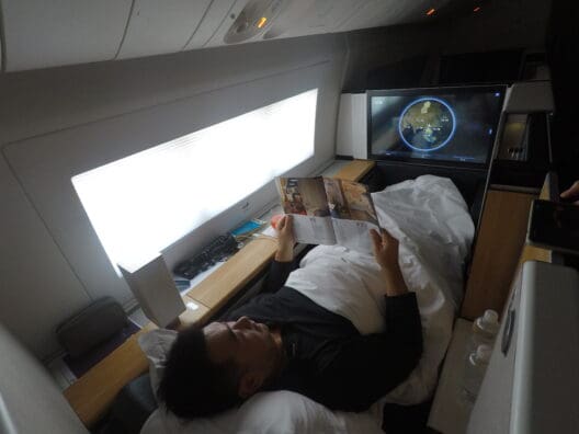 a man lying in bed reading a book