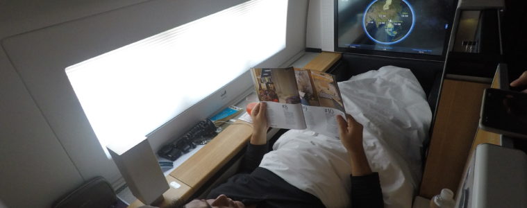 a man lying in bed reading a book