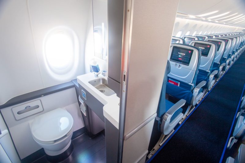 a bathroom with a sink and toilet in an airplane