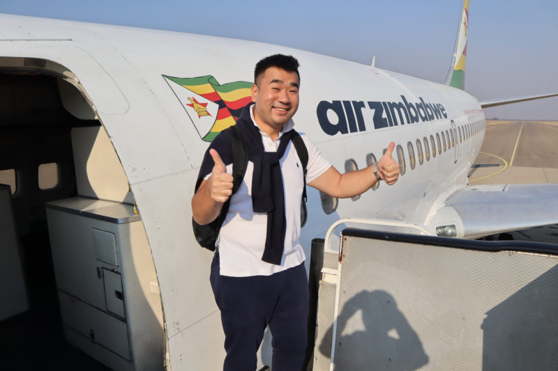 a man standing in front of an airplane