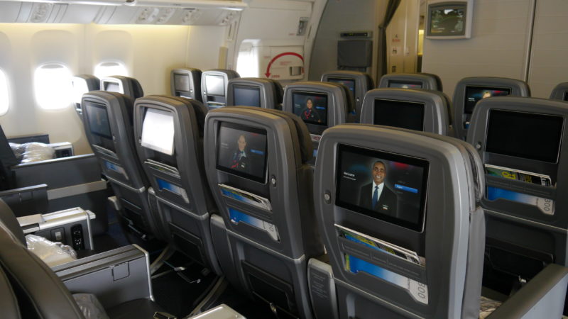a row of seats with tvs on the back