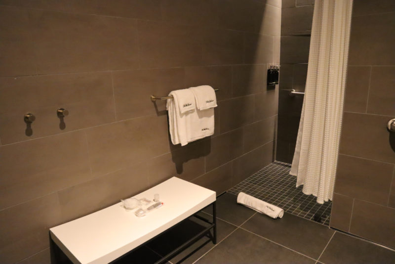a bathroom with a bench and shower