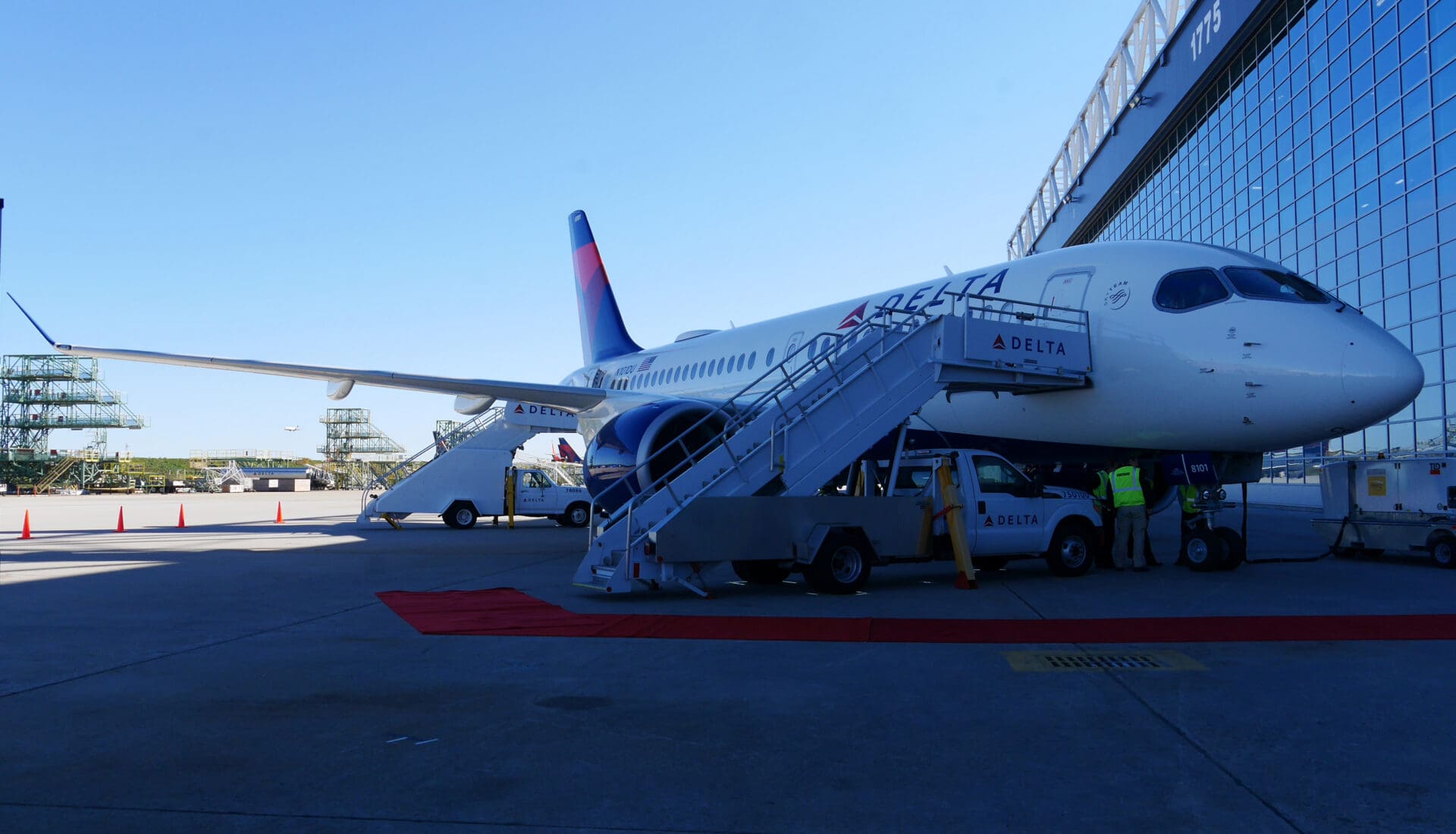 a plane with stairs and people standing next to it
