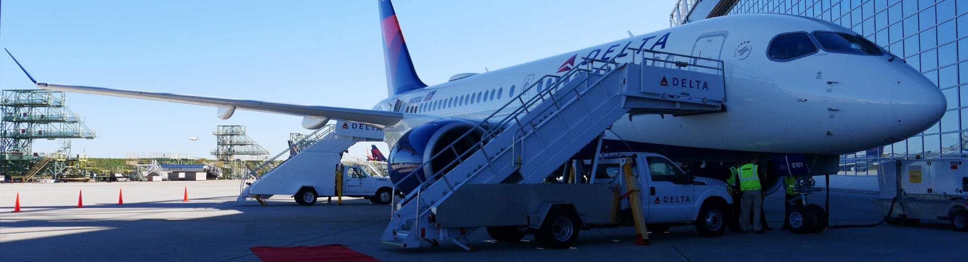 a plane with stairs and people standing next to it