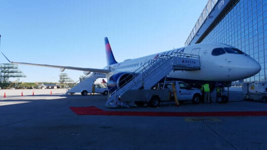 a plane with stairs and people standing next to it
